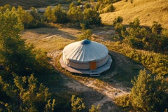 aerial-view-yurt-with-distinct-circular-layout-set-against-natural-landscape